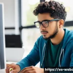 웹개발자 실무 경험 - A modern web developer workspace showing a young Hispanic man in casual attire wearing glasses and f...